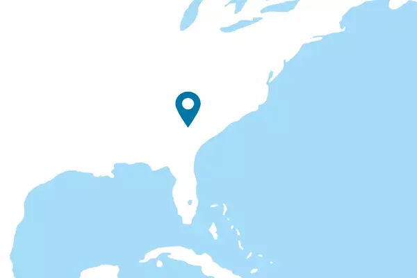 Graphic: Aurubis: View of world map in white with a dot on Richmond, Augusta